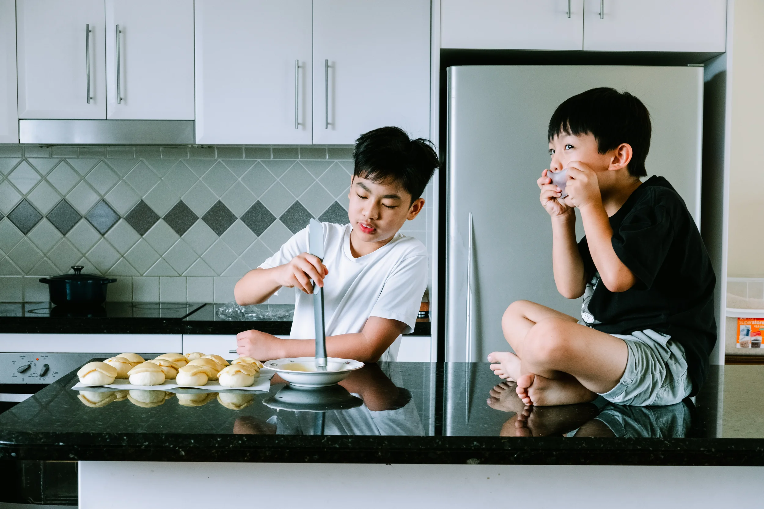 Two boys mid-play in the kitchen