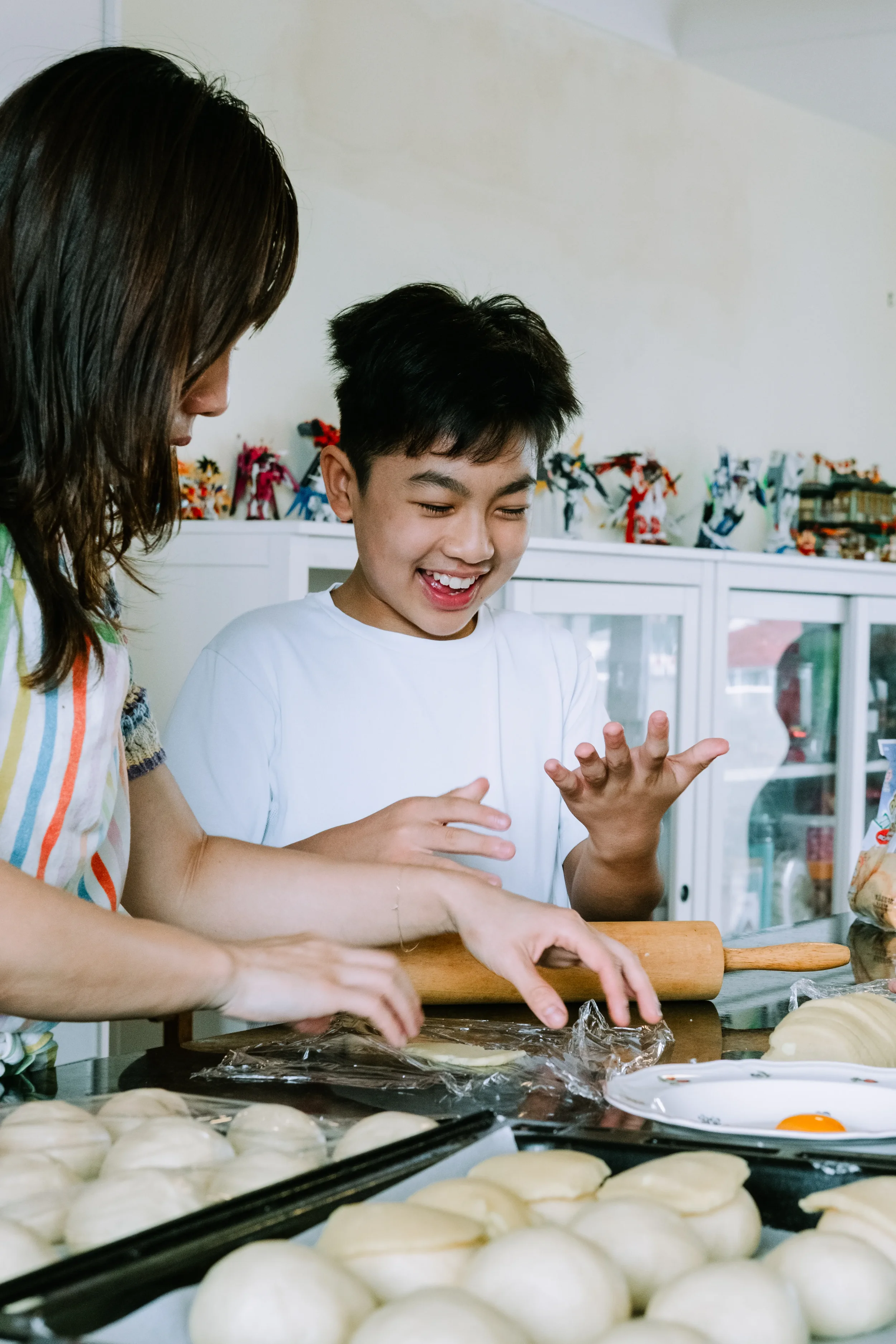Mum and her son baking together on the kitchen counter