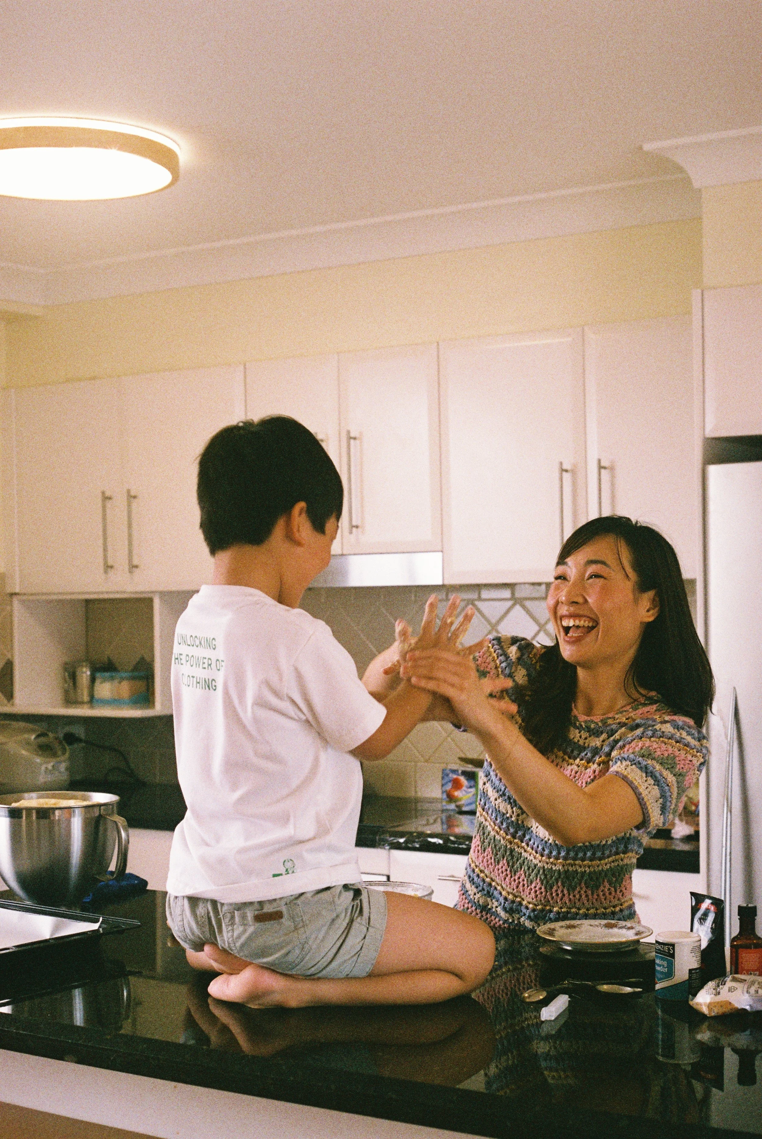 Mum and her son playing together in the kitchen