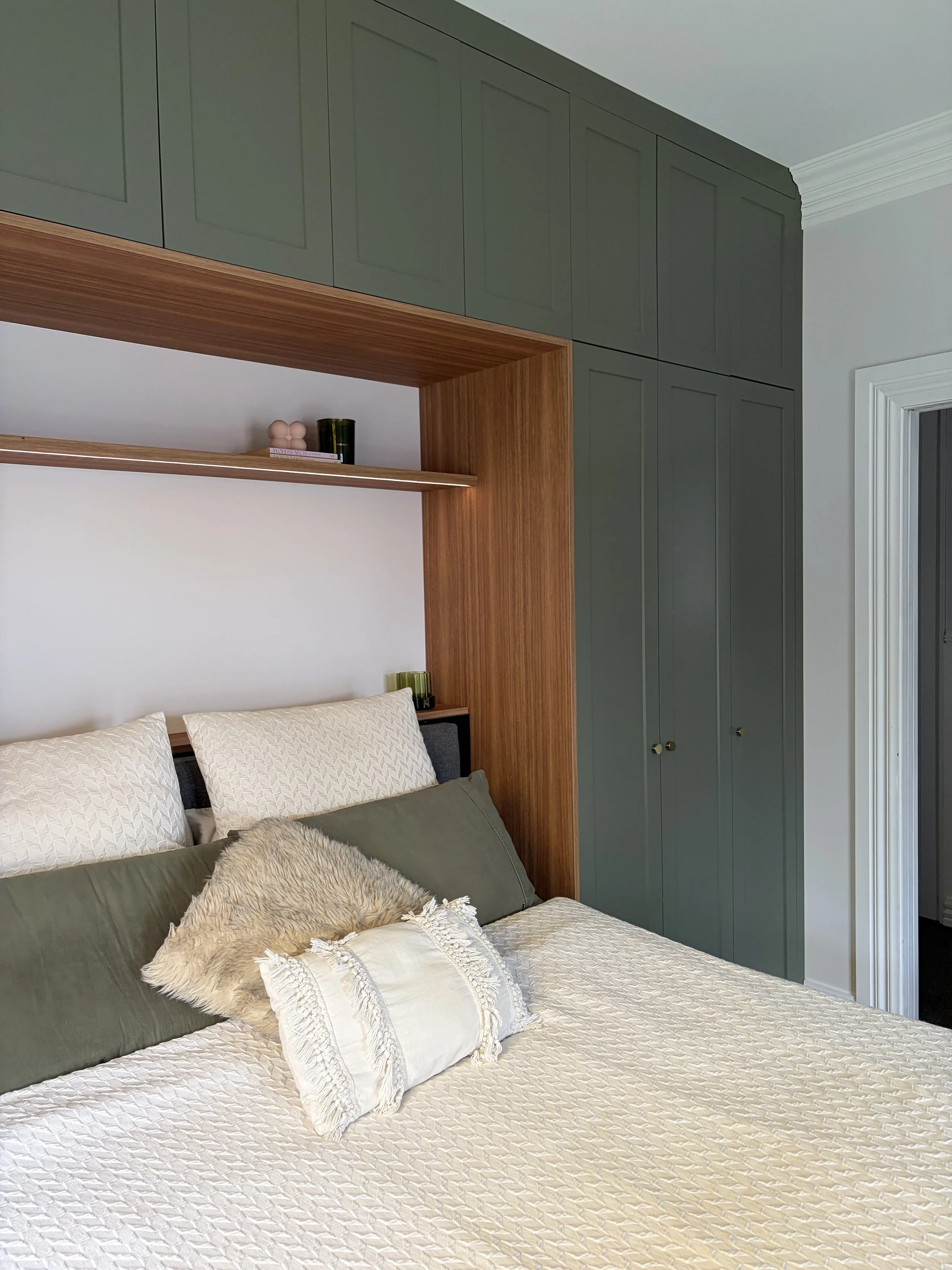 feature wall and custom made master wardrobe. green slate shaker style cabinetry