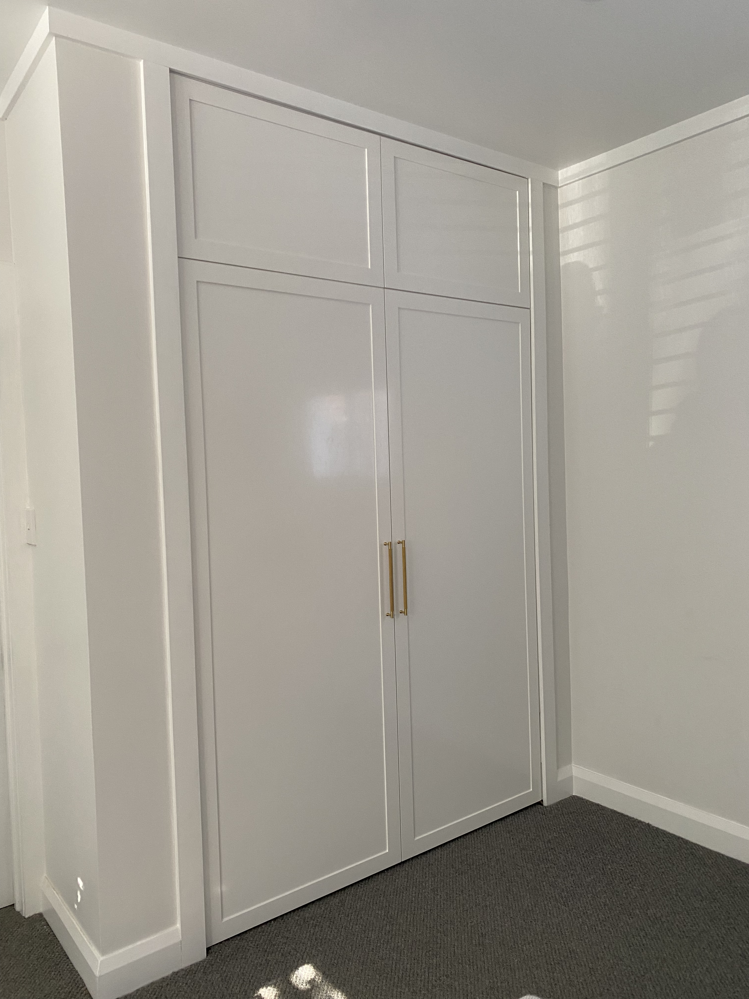 Pull-down bed that looks like a clean closed wardrobe or cabinetry