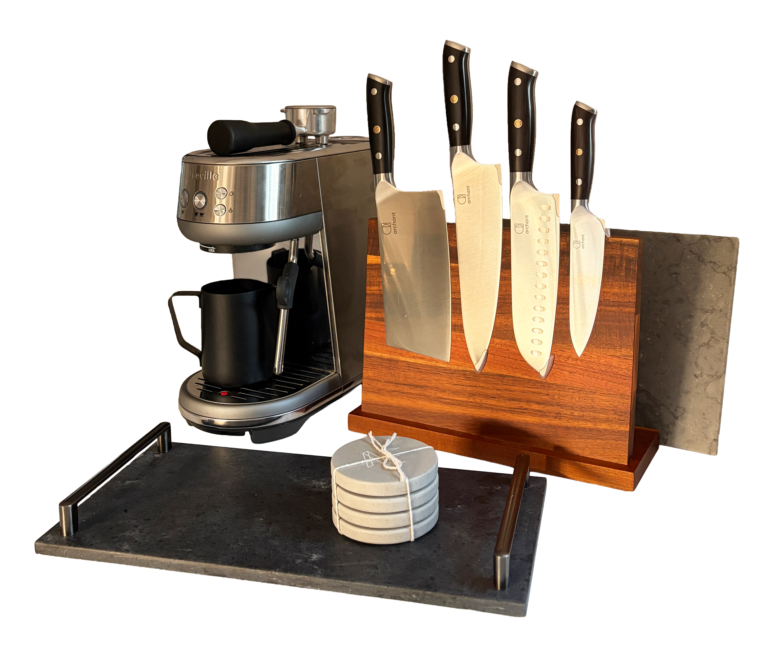 Set of kitchen knives with black handles and a coffee machine on a black countertop, with a wooden block with round holes for knives and a stack of four white plates tied with string.