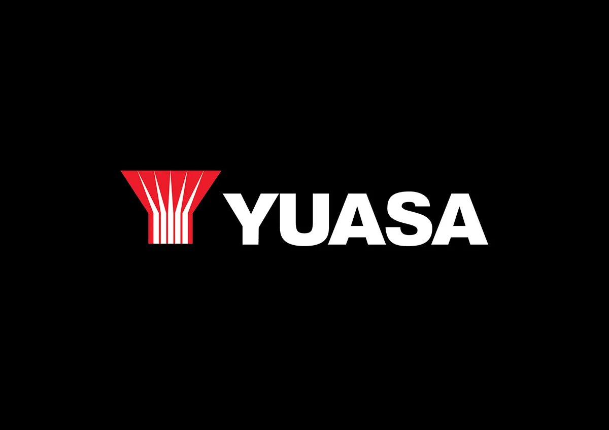 LED Electrical Wholesalers - Yuasa logo featuring a red graphic element and white capital letters on a black background.