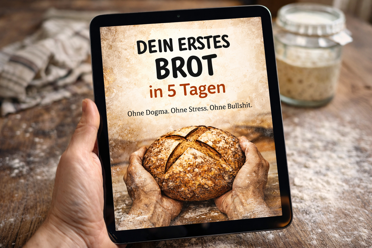 Bild eines Tablets, das eine Werbung für ein Programm zeigt, das verspricht, innerhalb von 5 Tagen ein erstes Brot ohne Dogma, Stress oder Bullshit zu backen. Auf dem Bildschirm ist ein Bild von einem handgebackenen Laib Brot, der in den Händen gehalten wird.
