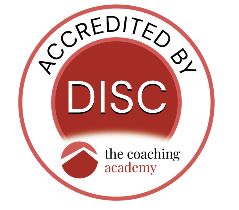 A circular logo with a red center and white border that reads "Accredited by DISC." Below, there is a red and white shield-like emblem with a slope. Underneath, it says "the coaching academy" with "the coaching" in black and "academy" in red.