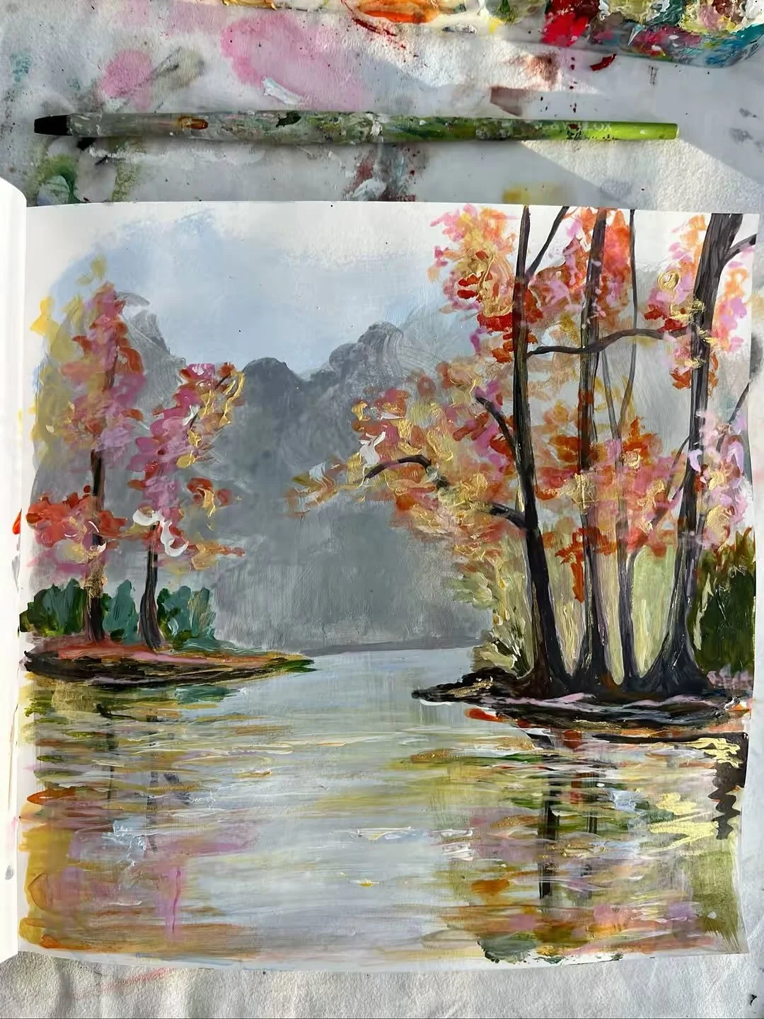 it&rsquo;s officially that time of year🍂🫶🧡 my favourite thing about this autumn painting is the really subtle pastel pink against the orange &amp; yellowsssss 💛🧡🩷. ofc the reflection in the water too.. i do love a sketchbook study 🥹