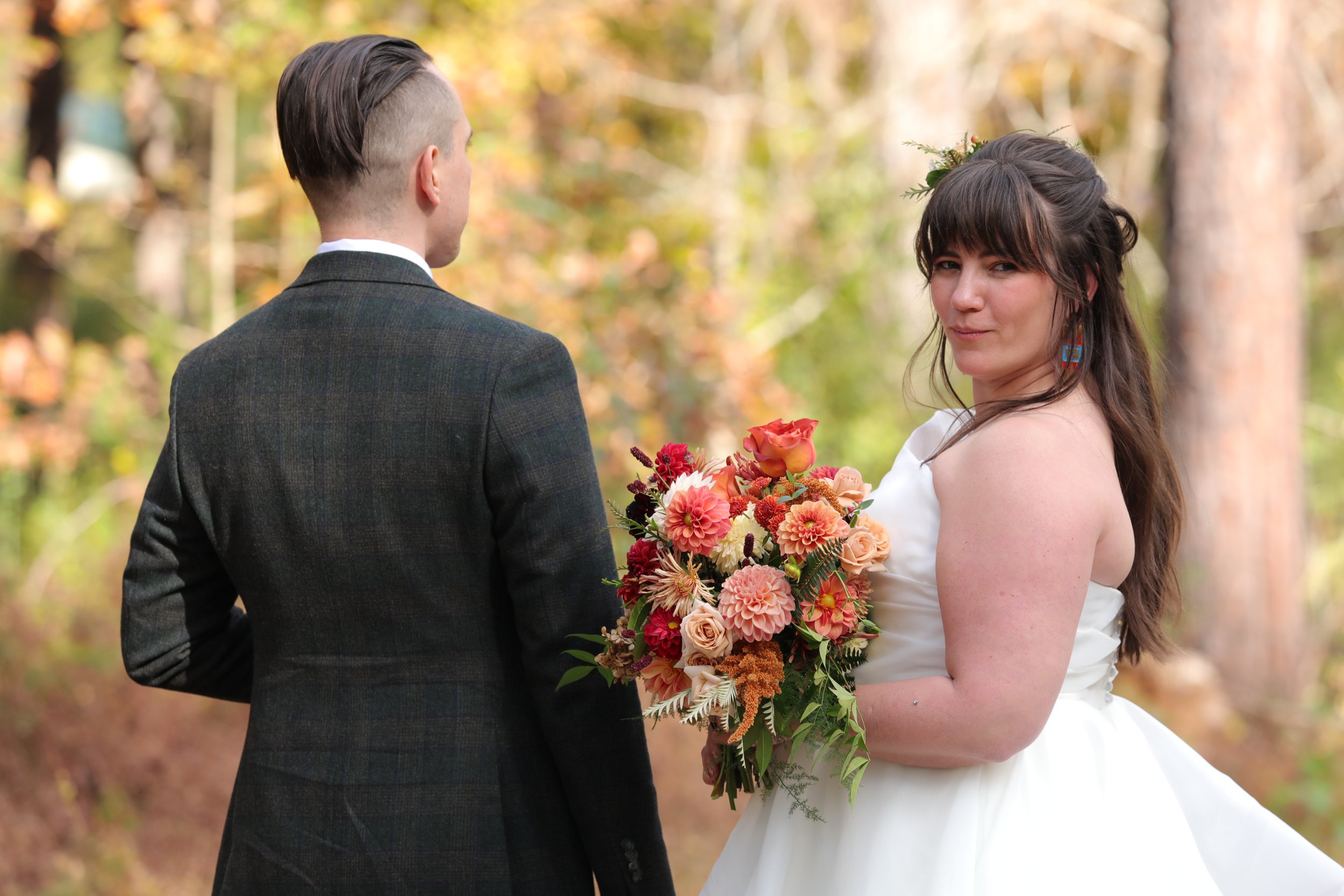 Bride and groom walk in the woods at the Honeysuckle Tea House