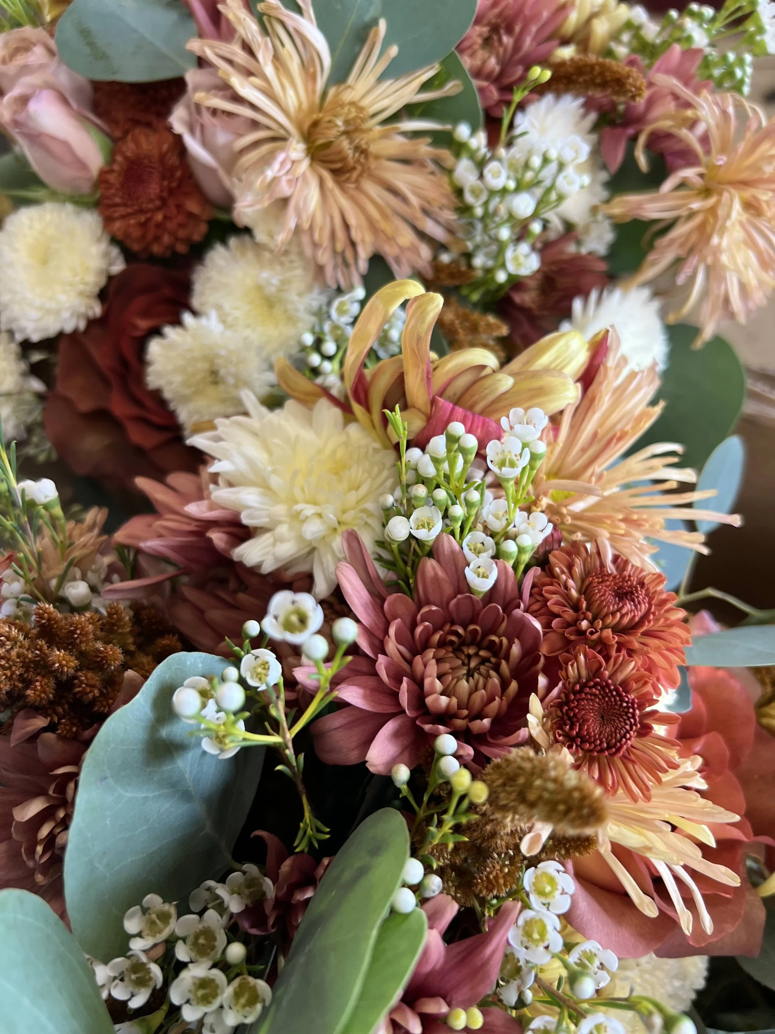 Closeup of rust and cream fall wedding flowers in Pittsboro, NC