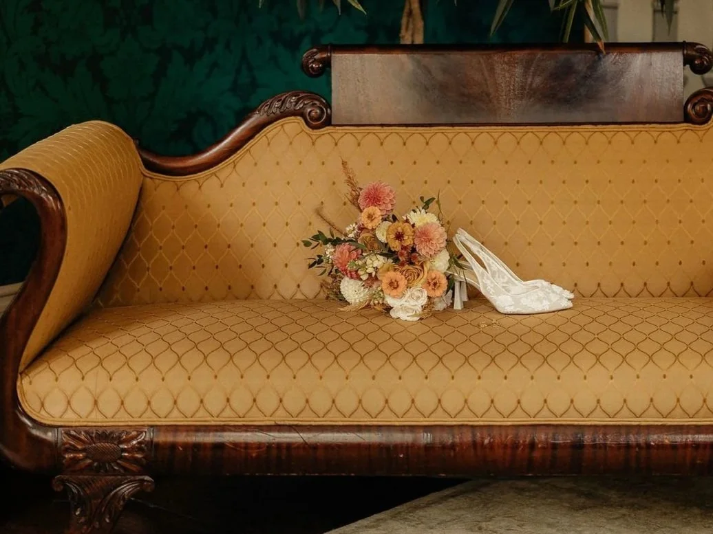October dahlia bridal bouquet on a sofa at the Sutherland in Raleigh, NC