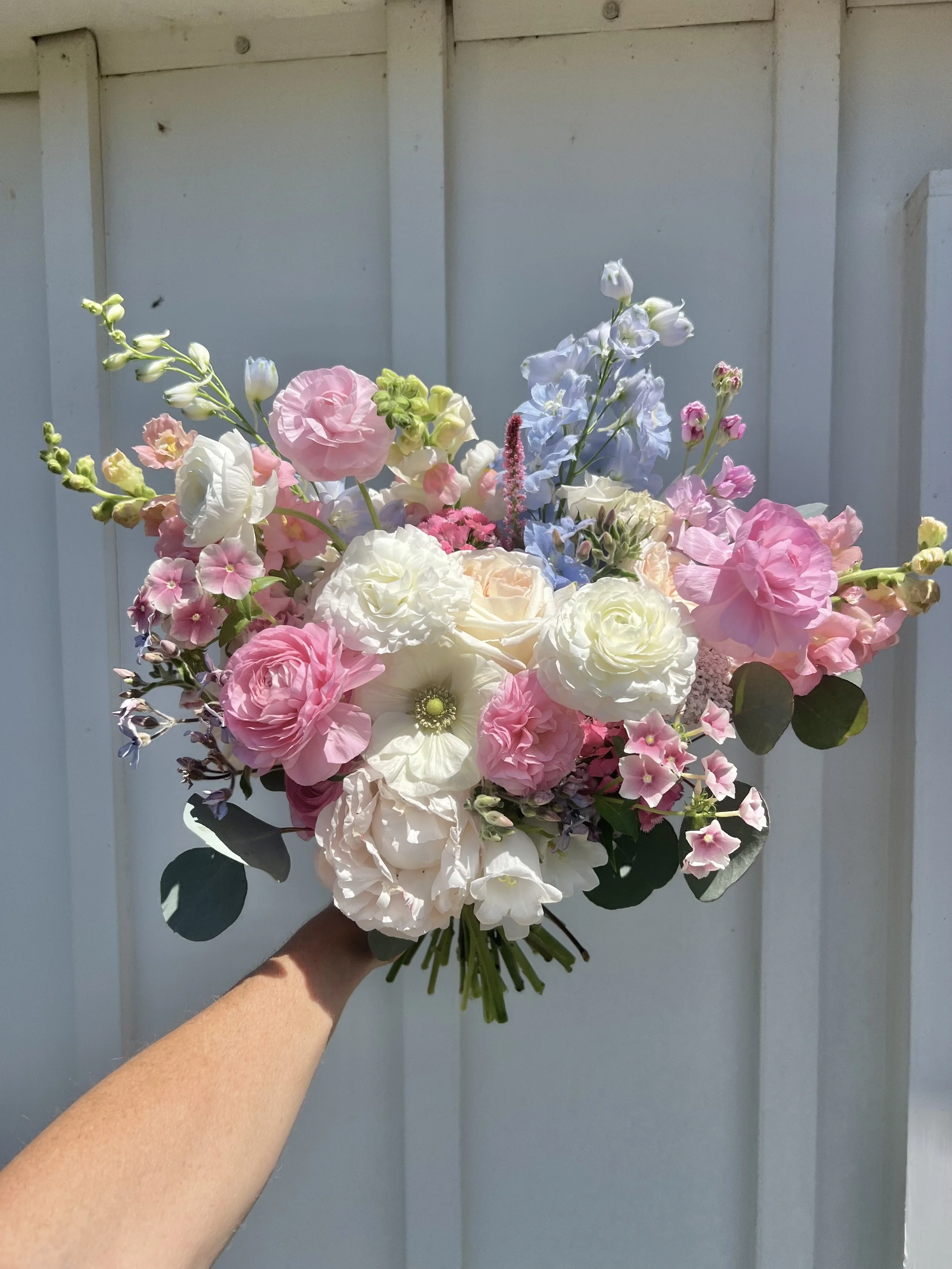 A pink and blue pastel spring bridal bouquet from Buck Naked Farm in Pittsboro, NC