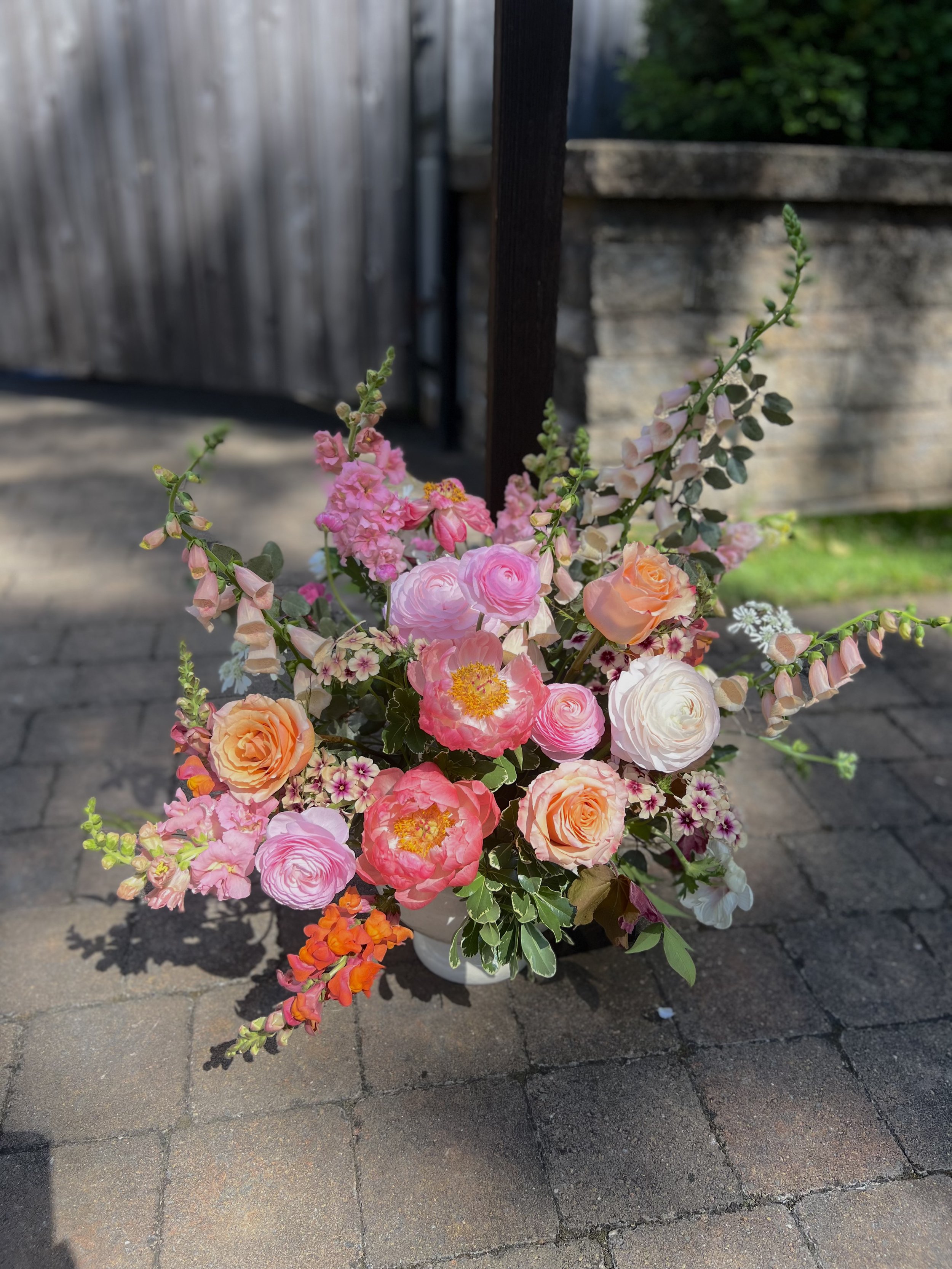 A bright pink spring wedding altar arrangement at the Cookery in Durham, NC