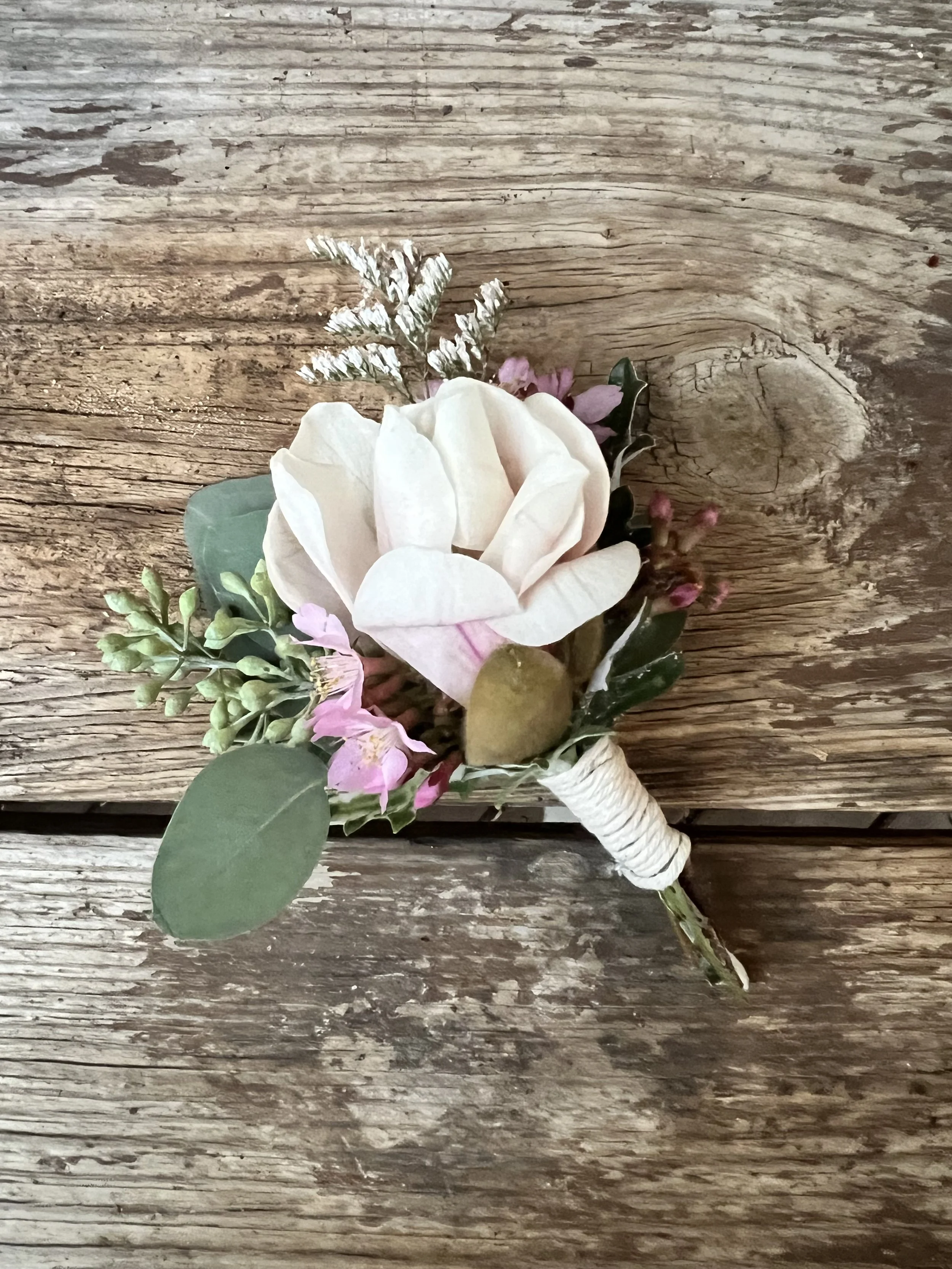Spring magnolia and cherry blossom boutonniere