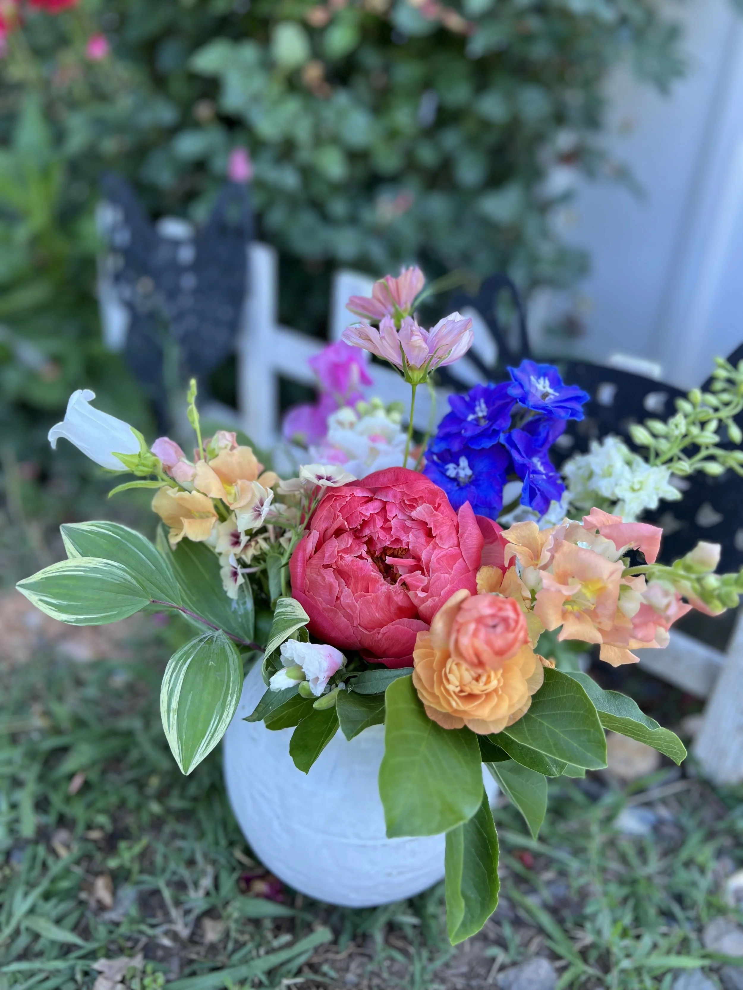 A colorful coral and blue spring wedding centerpiece for a country microwedding in Pittsboro, NC