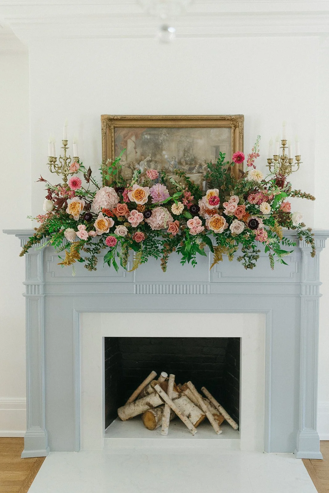 Blush and burgundy fall wedding flowers cover the fireplace at the 1893 House in Raleigh, NC