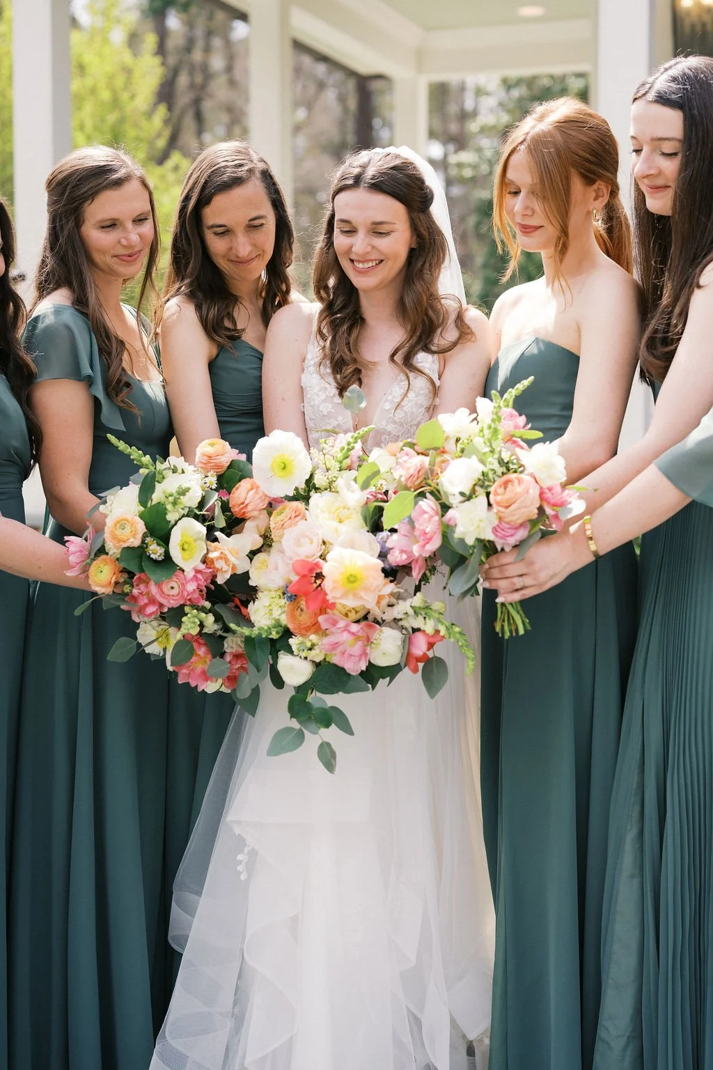 Pink, peach and sage spring bridal bouquet of tulips and ranunculus