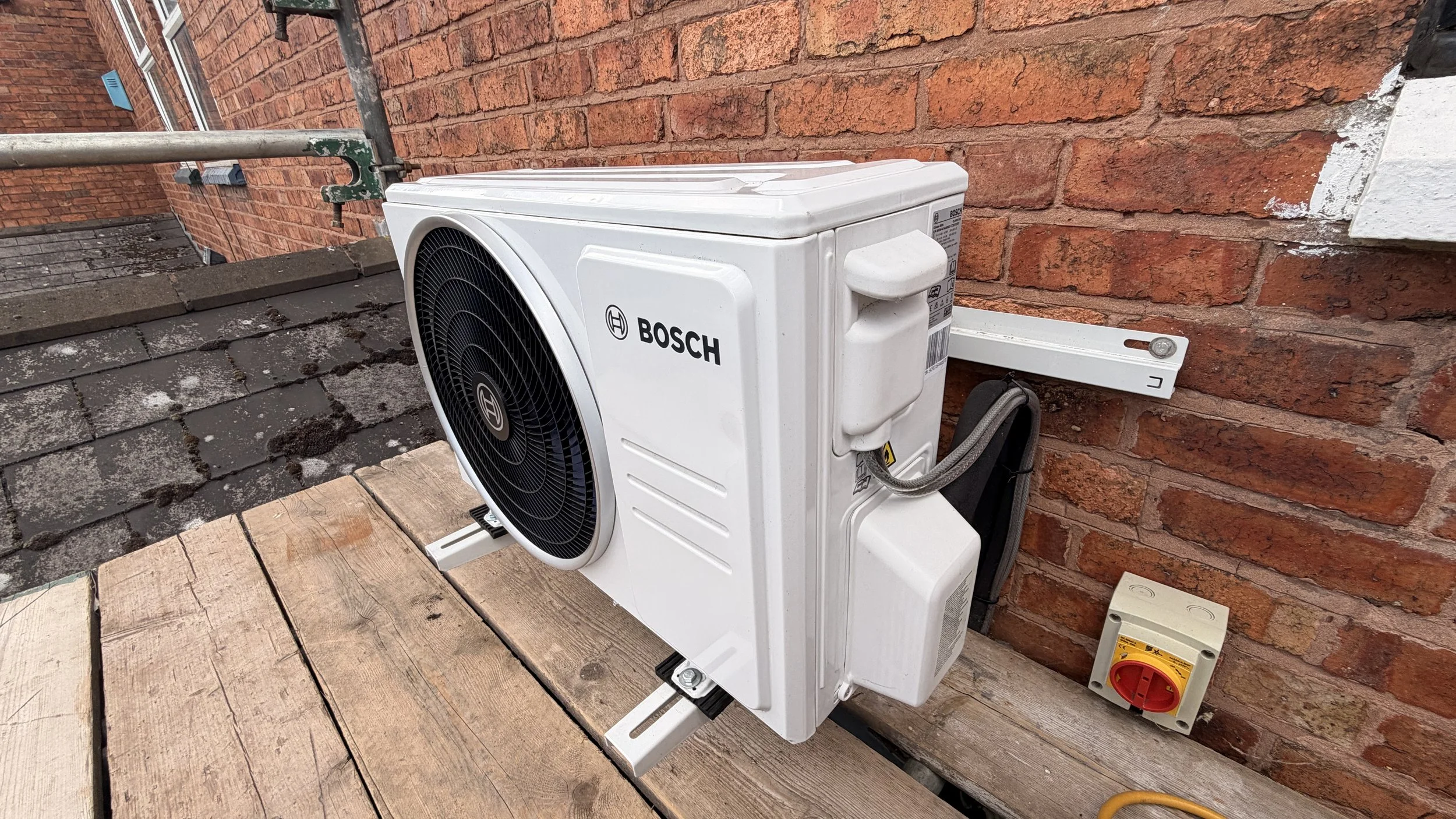 Outdoor Bosch air conditioning wall unit installed on outside of house. Plumbers Worcester Bosch.