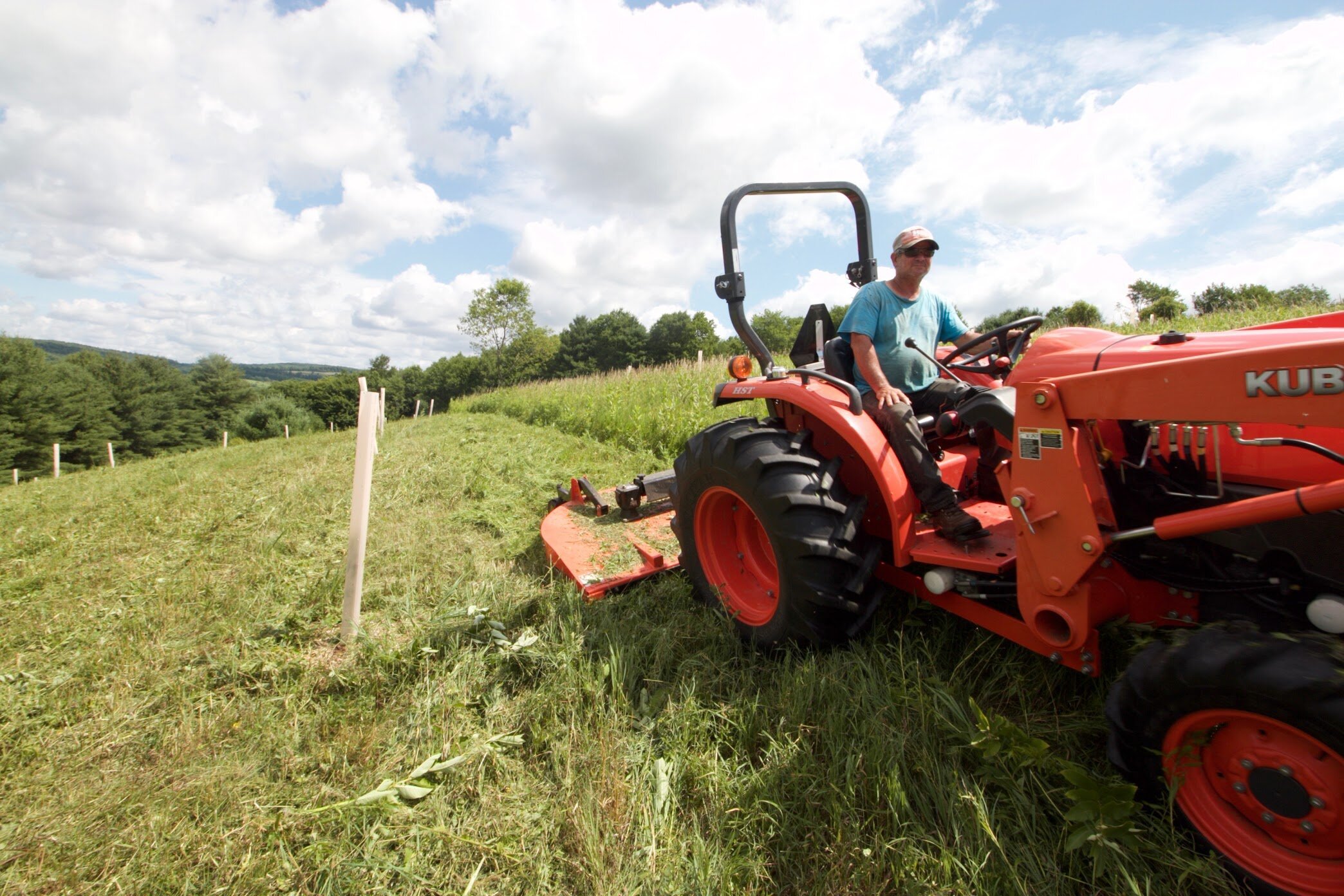 team-member-driving-tractor.jpeg