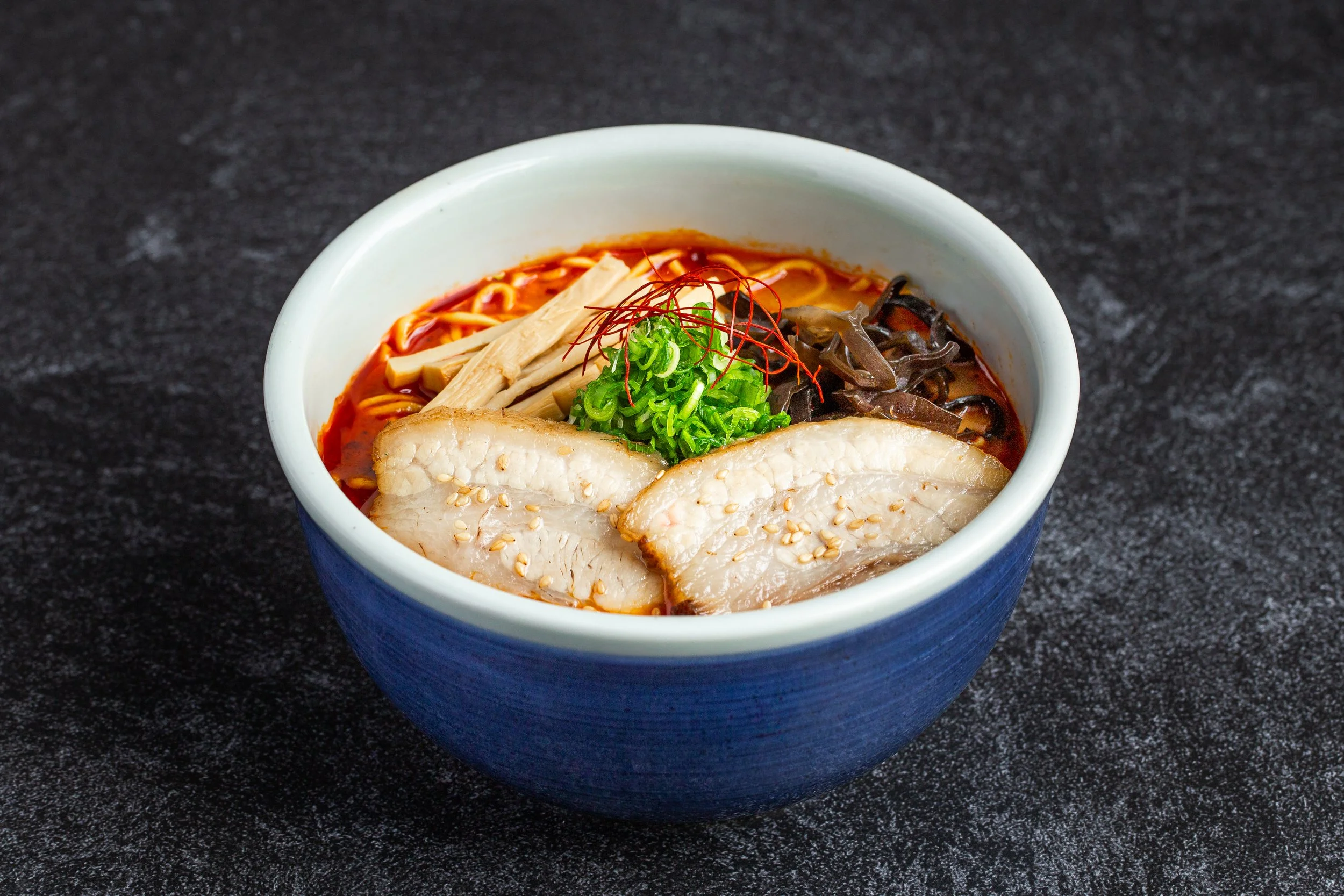 A bowl of spicy miso ramen with cha-siu, etc