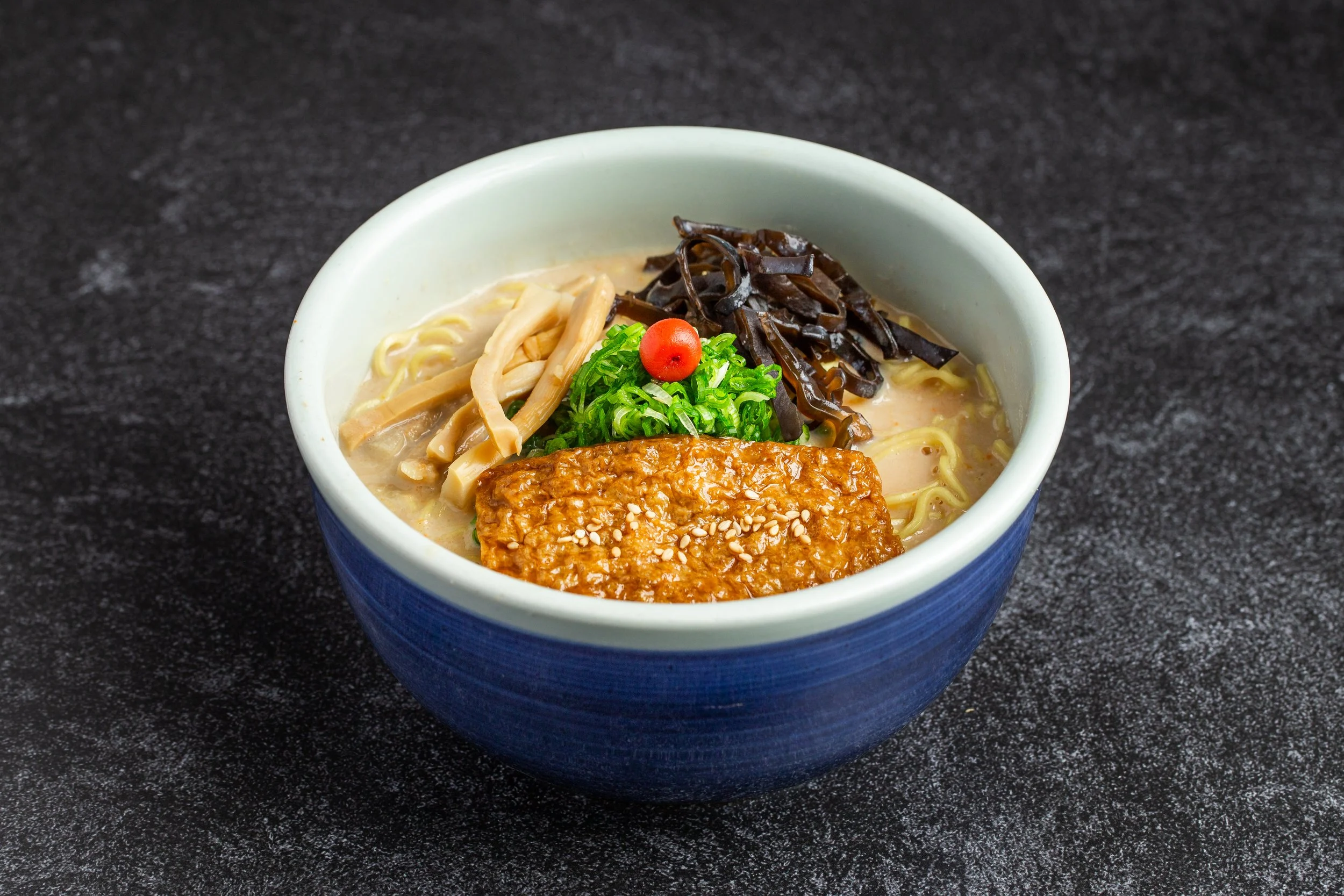 A bowl of vegetarian ramen with menma, kikurage and marinated fu and umeboshi