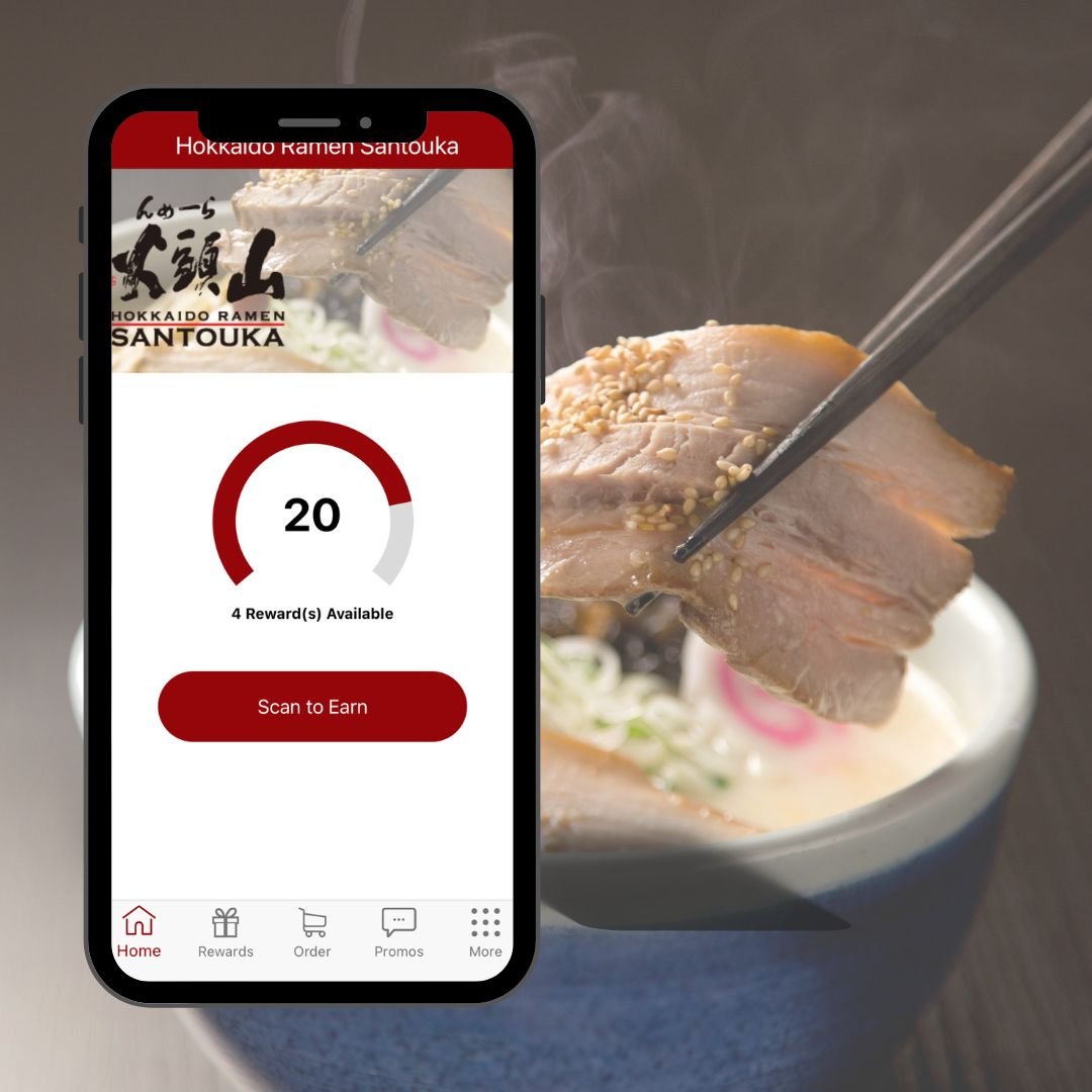 Image of santouka app in a smart phone with a bowl of ramen in the background