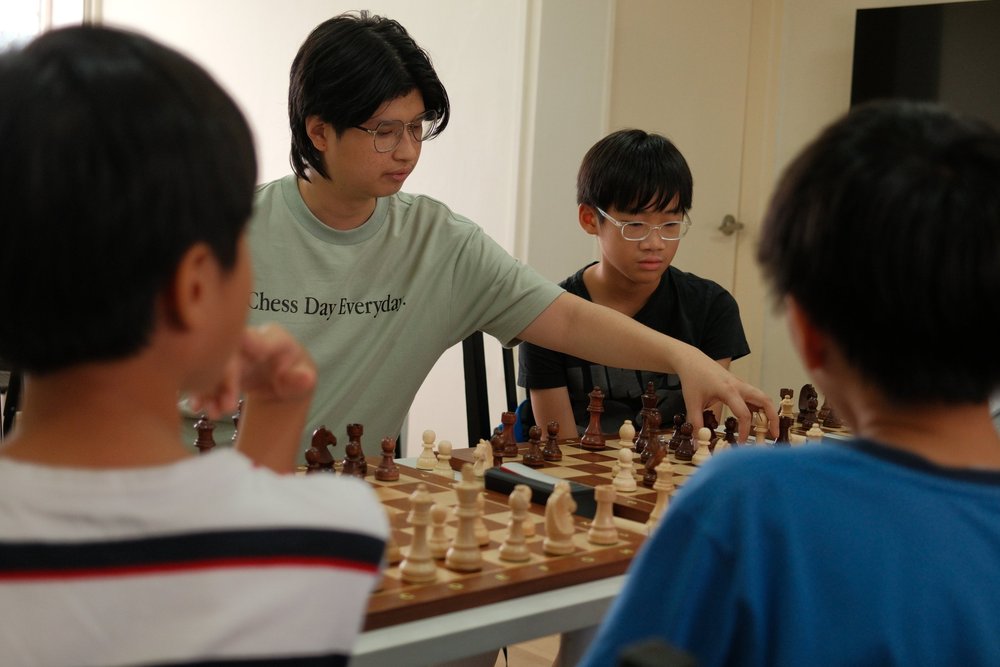 A Chess.sg coach demonstrating a move to students