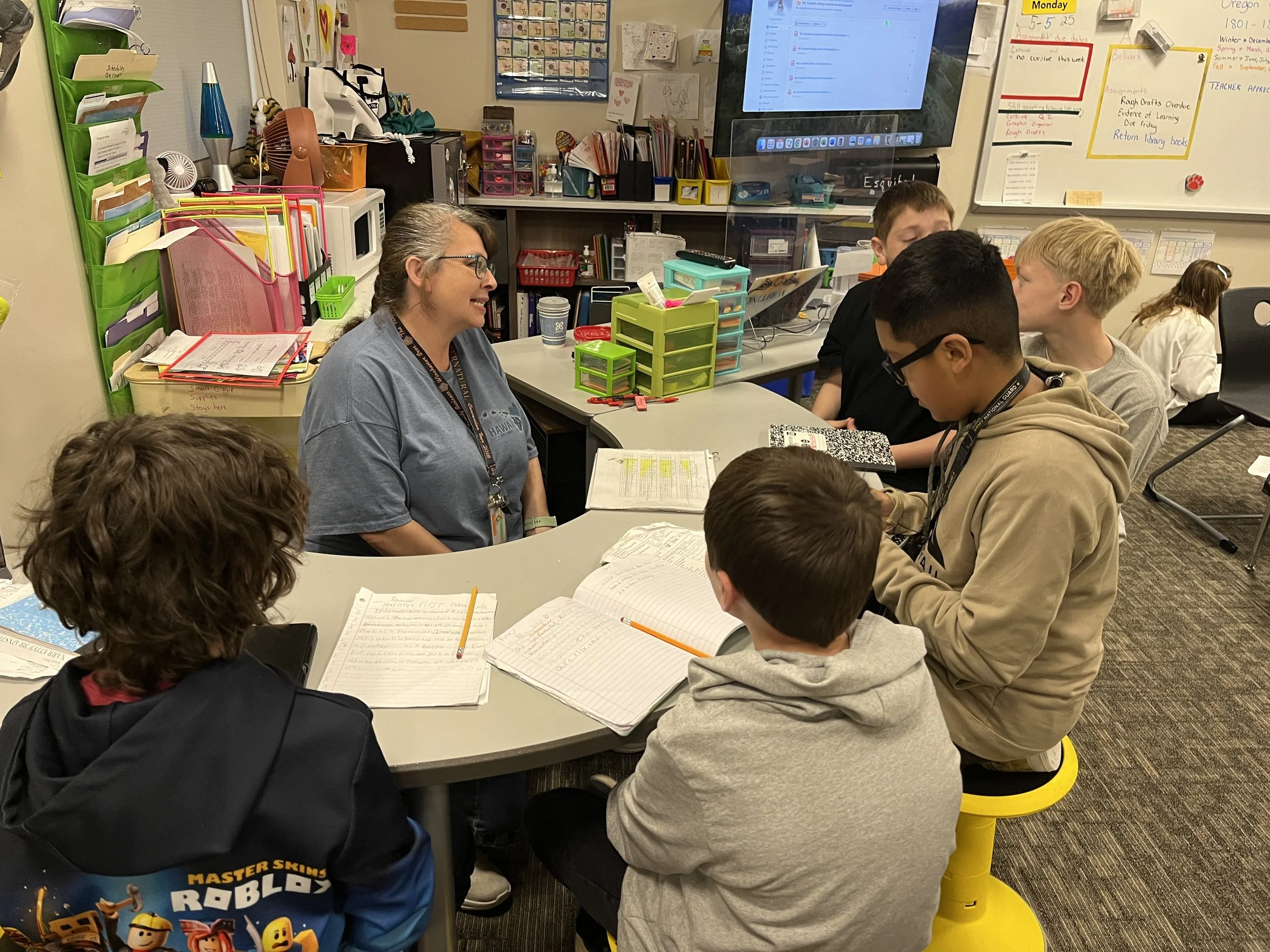 Students working with a teacher in a small group