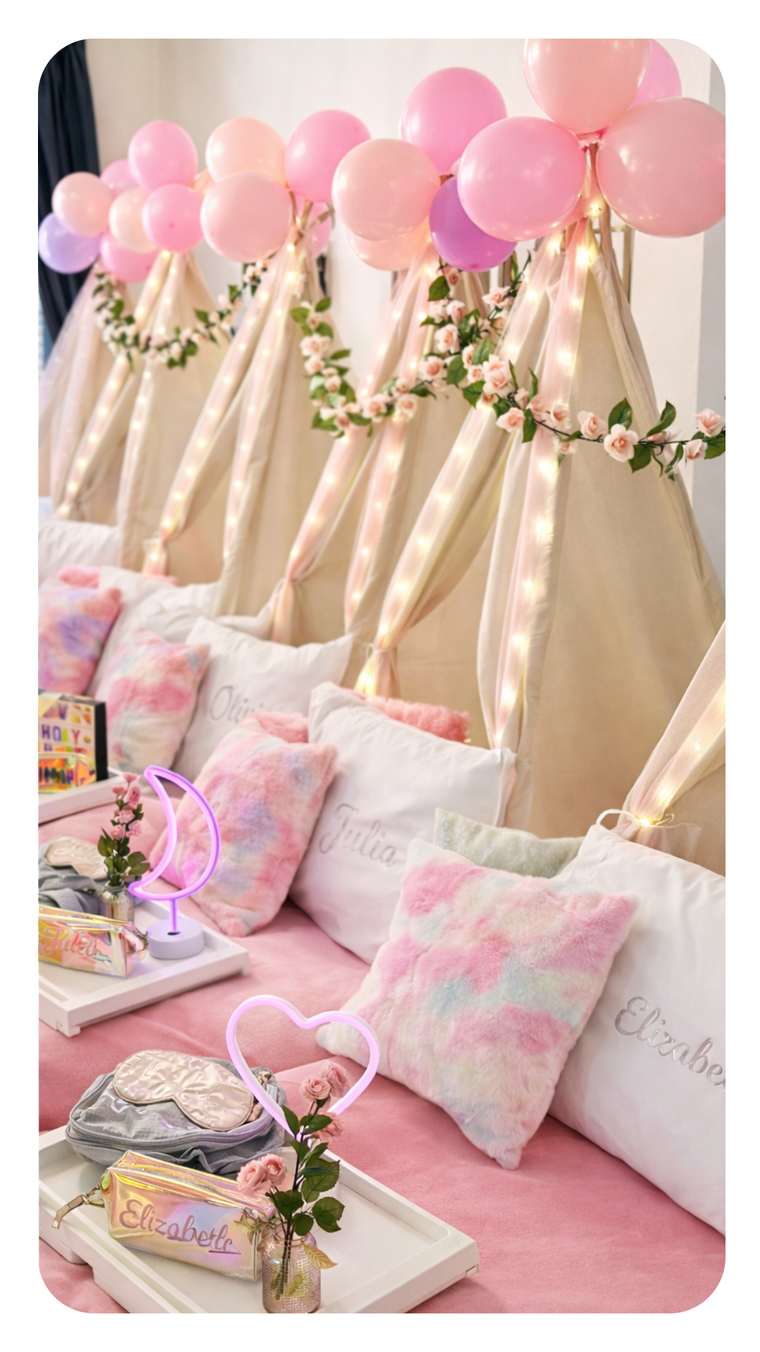 Decorated bedroom with pink and purple balloons, fairy lights, floral garlands, plush pillows, personalized pillows with names, pink bedspread, neon heart and moon shapes, and gifts for a celebration or birthday.