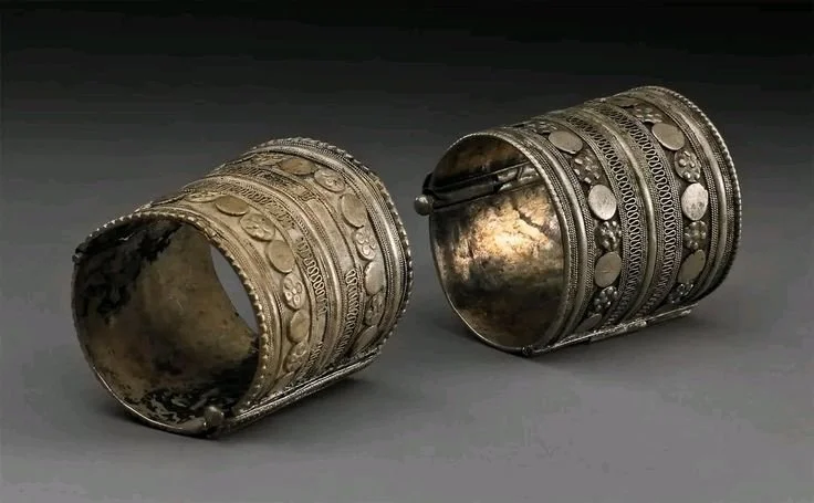 Traditional Somali silver cuff bracelets featuring intricate filigree work and a secure push-pin closure.