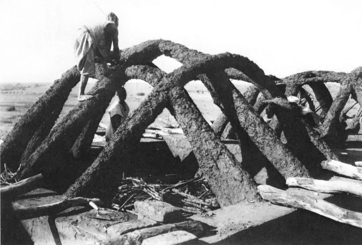 Hausa architecture. This image captures the construction of traditional Hausa vaults, this one under construction, in Tahoua, Niger, circa 1928.