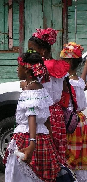 Guadeloupean children wearing madras skirts and headwraps.