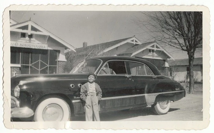 The Princetta R. Newman Collection of Family Photographs, Tulsa, Oklahoma. (n.d.-g). Photographic print of young boy standing in front of a car, ca. 1949. Collection of the Smithsonian National Museum of African American History and Culture, Gift of 