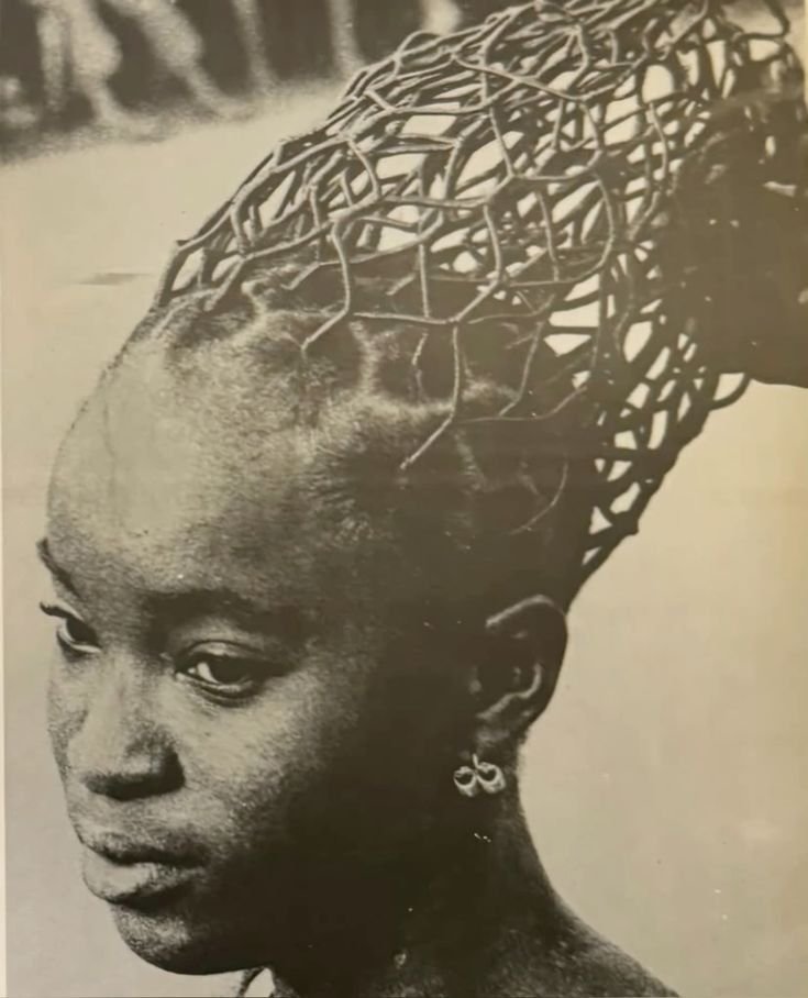 Woman with elaborate hairthreading hairstyle, photographed by J.D. ’Okhai Ojeikere, from the Hairstyles series (Nigeria, 1968–1975). 