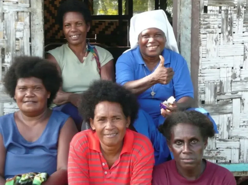 A group portait of Maniq people sitting down  — Image via Livity.Blog