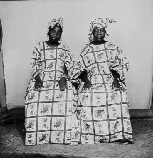 Two women wearing traditional African Surinamese Koto dresses photographed by Malick Sidibe 