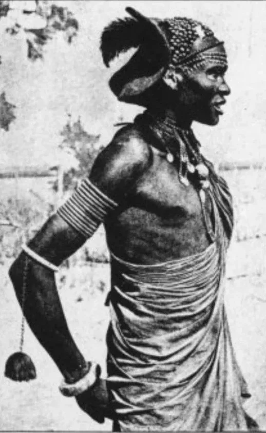 Traditional Shilluk lawo (wrapped cloth attire) and a masterly mud-sculpted coiffure worn by a warrior of the Shilluk (Chollo) people in South Sudan.