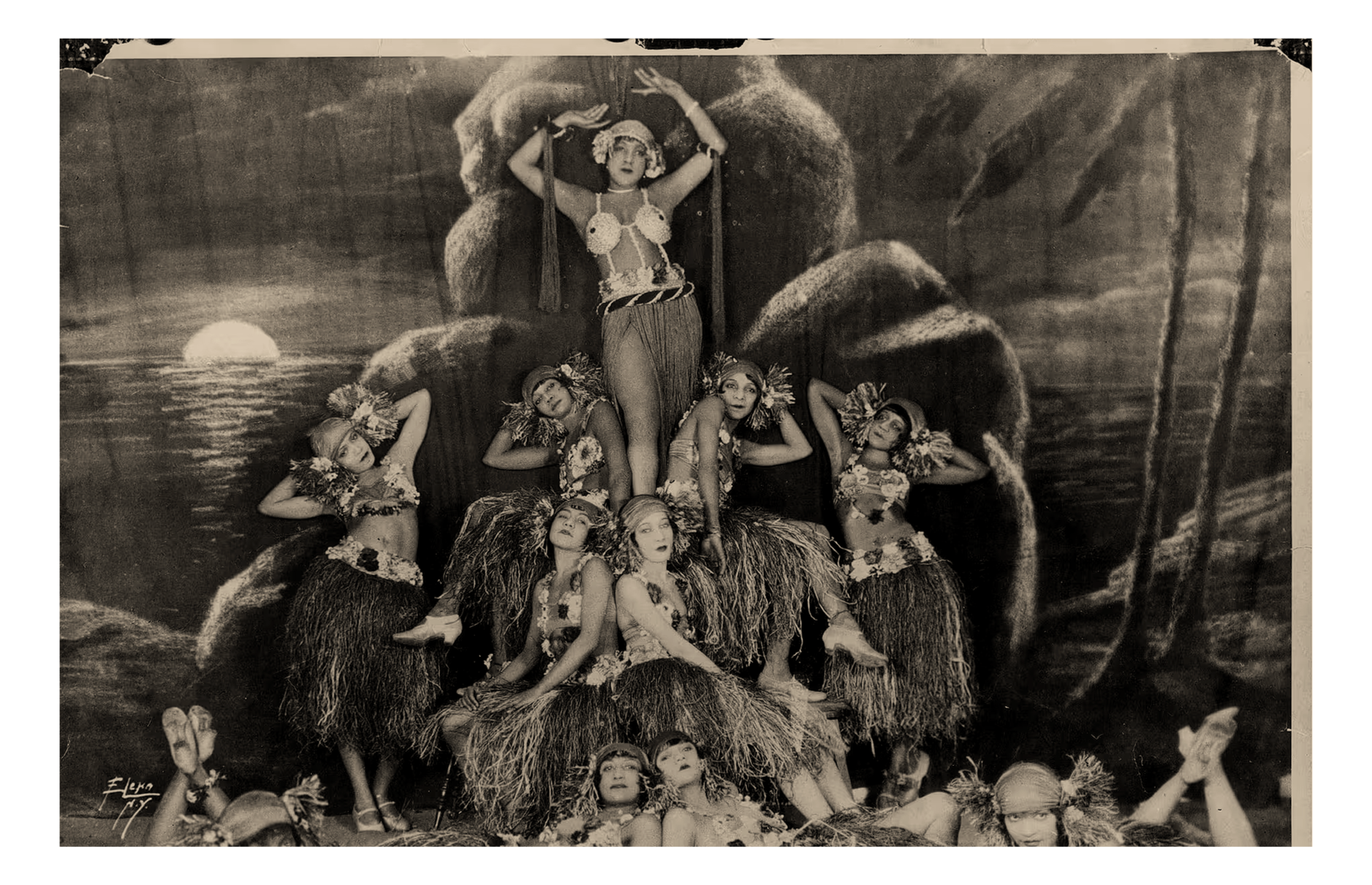 A troupe of showgirls as they pose in costume on stage in Harlem, New York, circa 1920. Photographed by Anthony Barboza.