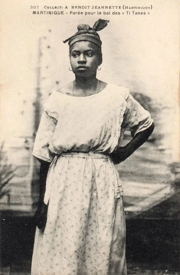 Martinican woman wearing a headwrap and simple Creole dress.