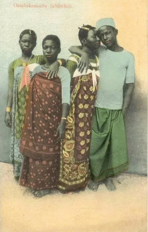 Swahili people from Zanzibar wearing kangas and kofias.