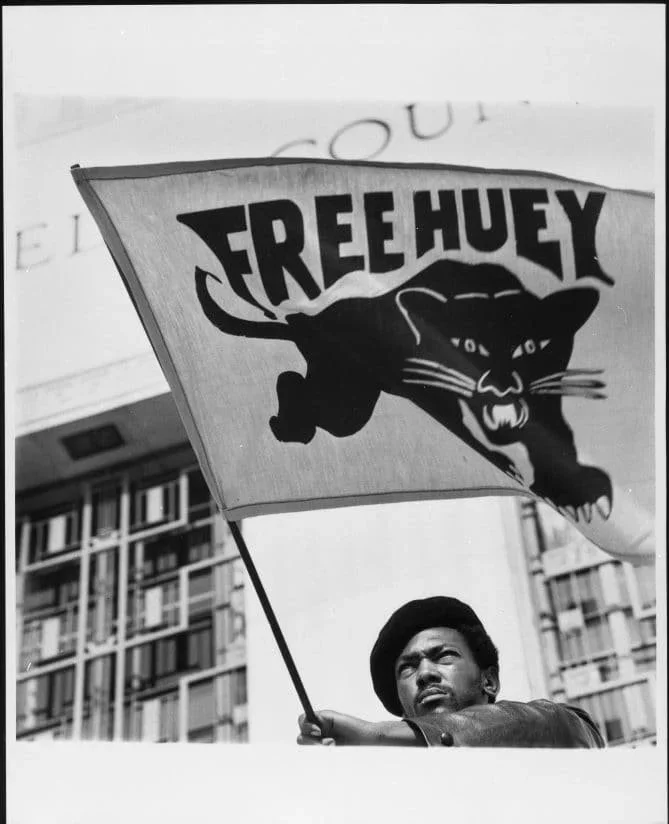 "Panther Flag", photograph by Jonathan Eubanks, 1969, Jonathan Eubanks photograph collection, MS 150, African American Museum & Library at Oakland, Oakland Public Library.