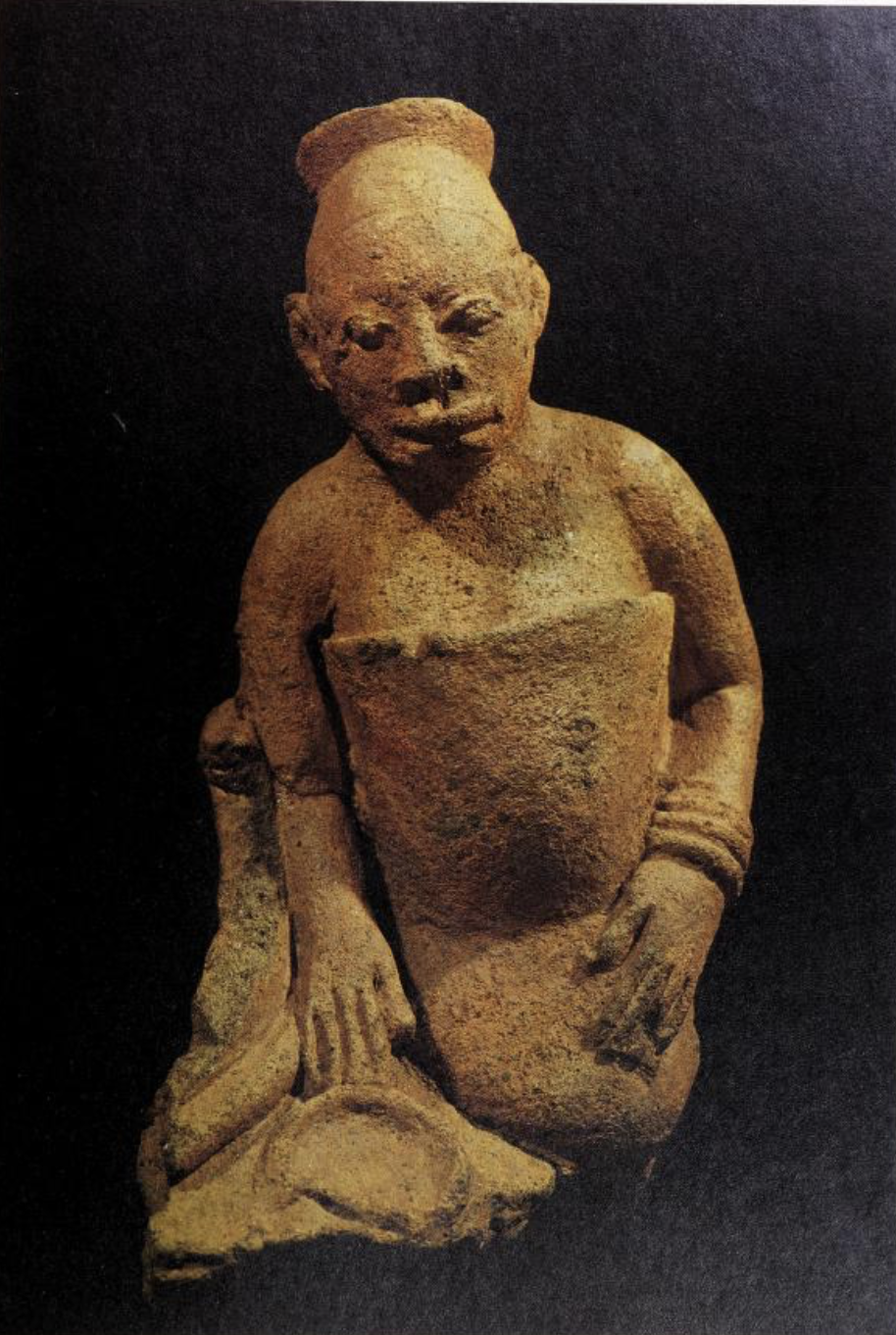 Terracotta human seated figure apparently broken from tableau. probably between the 12th and 15th centuries A.D. P.59. from Two thousand years, Nigerian art (1977).