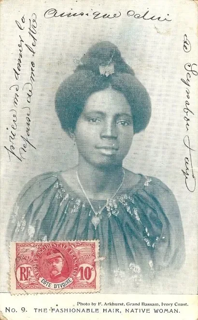 Woman from the African Coast photographed by F.W.H Arkhurst, with their hair swept high and adorned with gold ornament. Sourced from AdireAfricanTextiles.blogspot.com.
