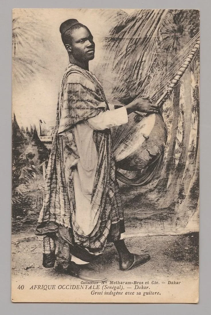 Griot from Senegal who is holding a kora. 