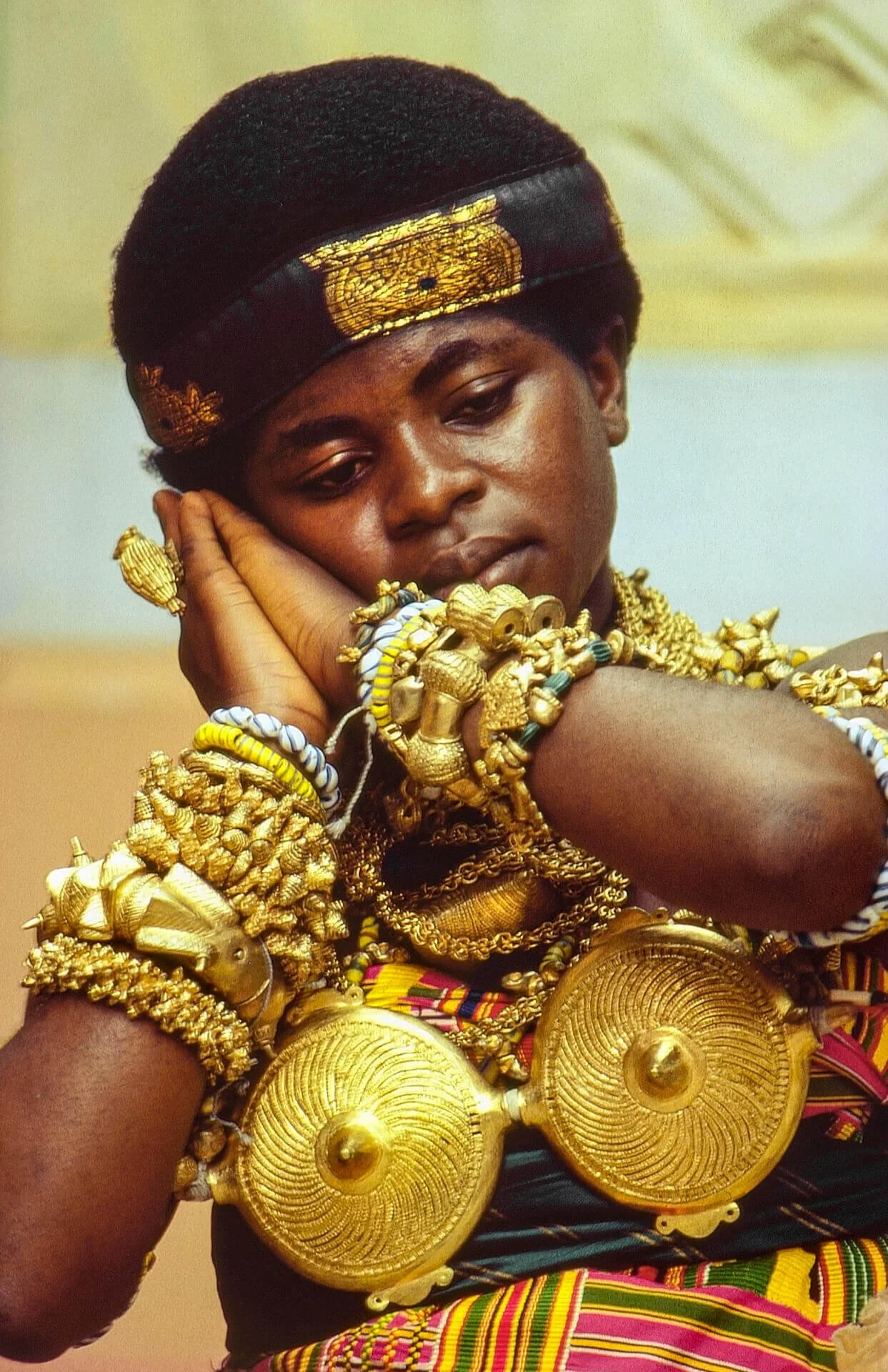 Ashanti Royal Dancer, Ghana. This image depicts a young Ashanti royal dancer adorned with gold regalia from the royal treasury, worn during important state ceremonies. Unknown photographer. (n.d.). Ashanti royal dancer, Ghana [Photograph]. Africa Onl