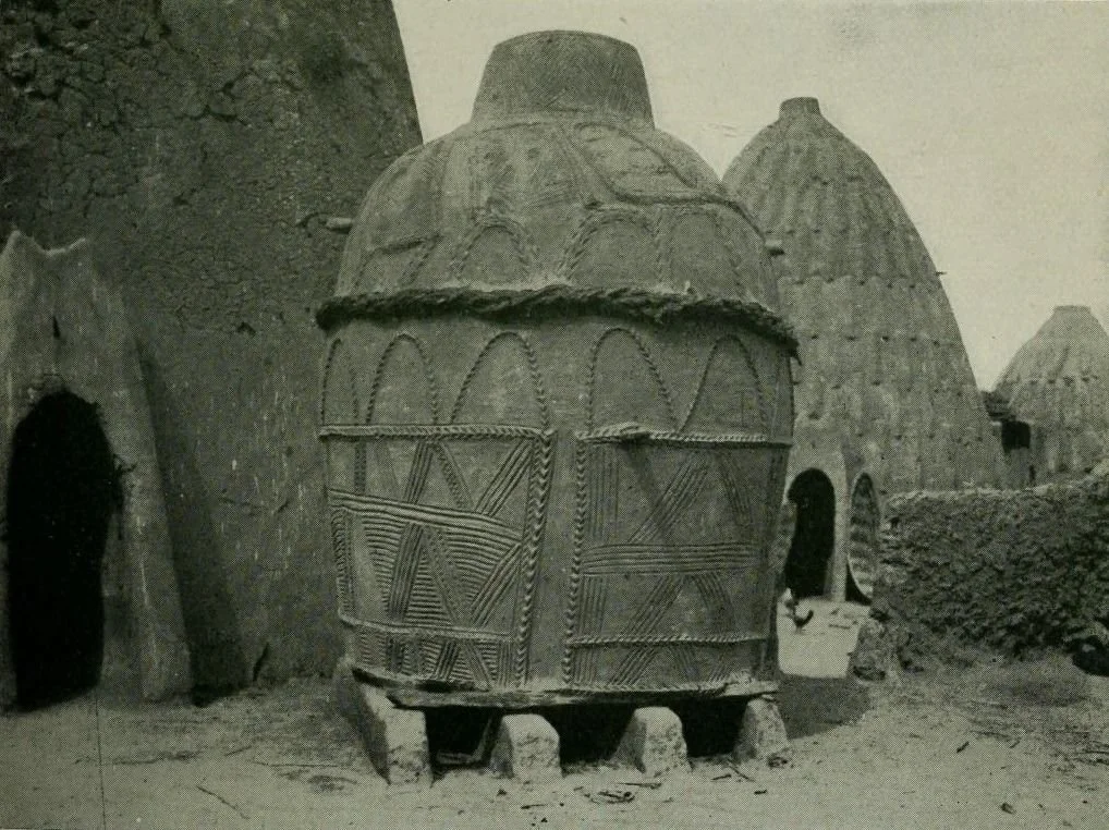 This image displays a traditional Musgum earthenware corn store. These structures are made by the Musgum people, who reside in parts of Cameroon and Chad.