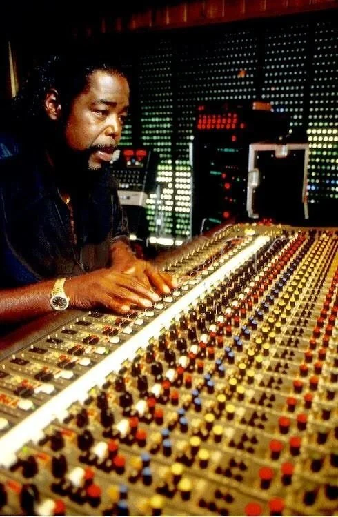 Barry White sitting with a sound mixer. 