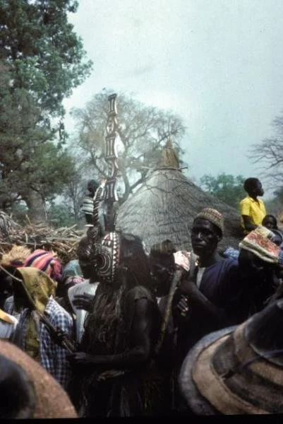 Mossi funeral north of Yako, 1977, Yatenga style karanse. The masks perform in front of the dead man's house.  via https://www.randafricanart.com/Mossi_mask_2.html