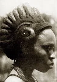 Igbo woman wearing an Ojongo crested hairstyle shaped with palm oil and charcoal dust.