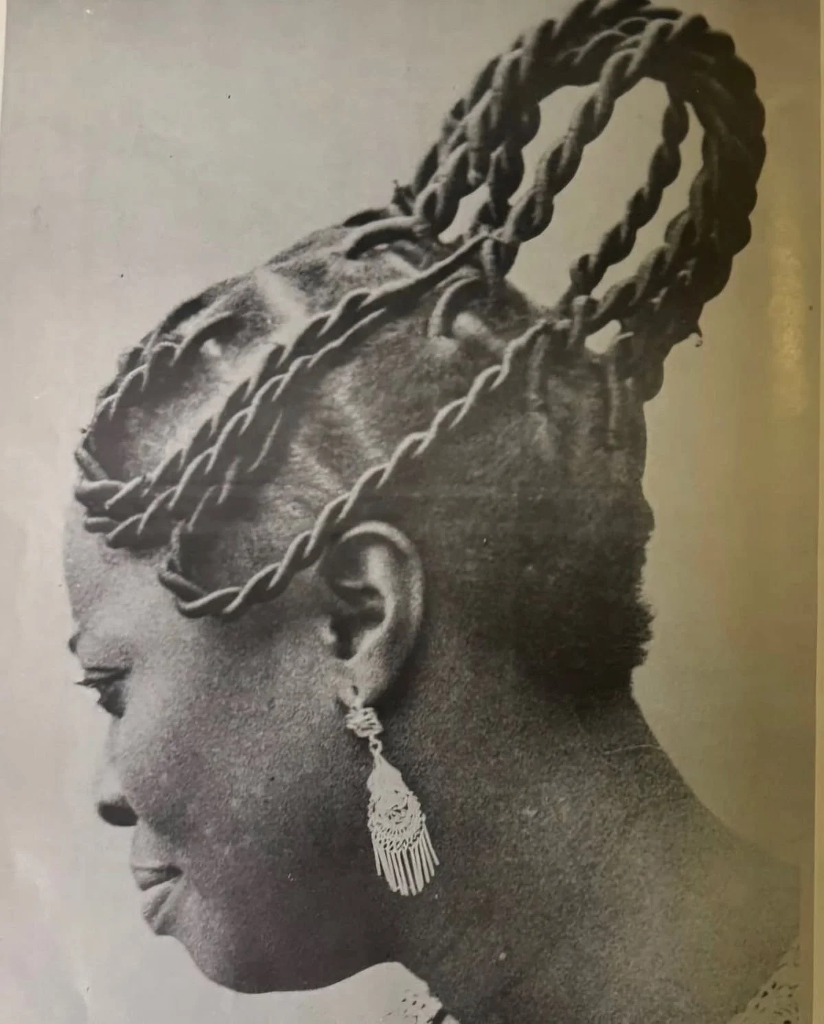 Scanned image from the book 'Traditional hairstyles for the black woman' privately published by Kunle Sonuga, 1976, showcasing traditional hairstyling options from Nigeria.