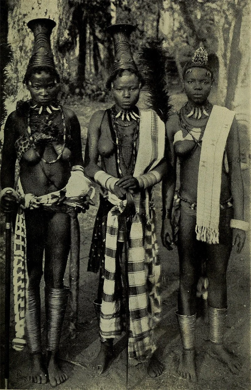 Three Igbo women and details of their attire including nja anklets and odu ivory bangles, akwa ocha (‘white fabric’) cloth, and a plaid-like cloth known today as George made primarily in the Igbo speaking town of Akwete. Photo taken by missionary G. 