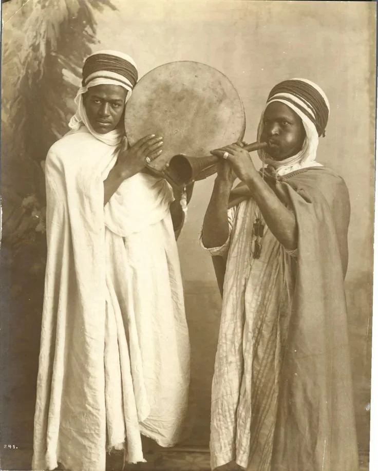 Northa Arab snake charmers, in Tangier, Morocco, playing the algaita and a hand drum. 